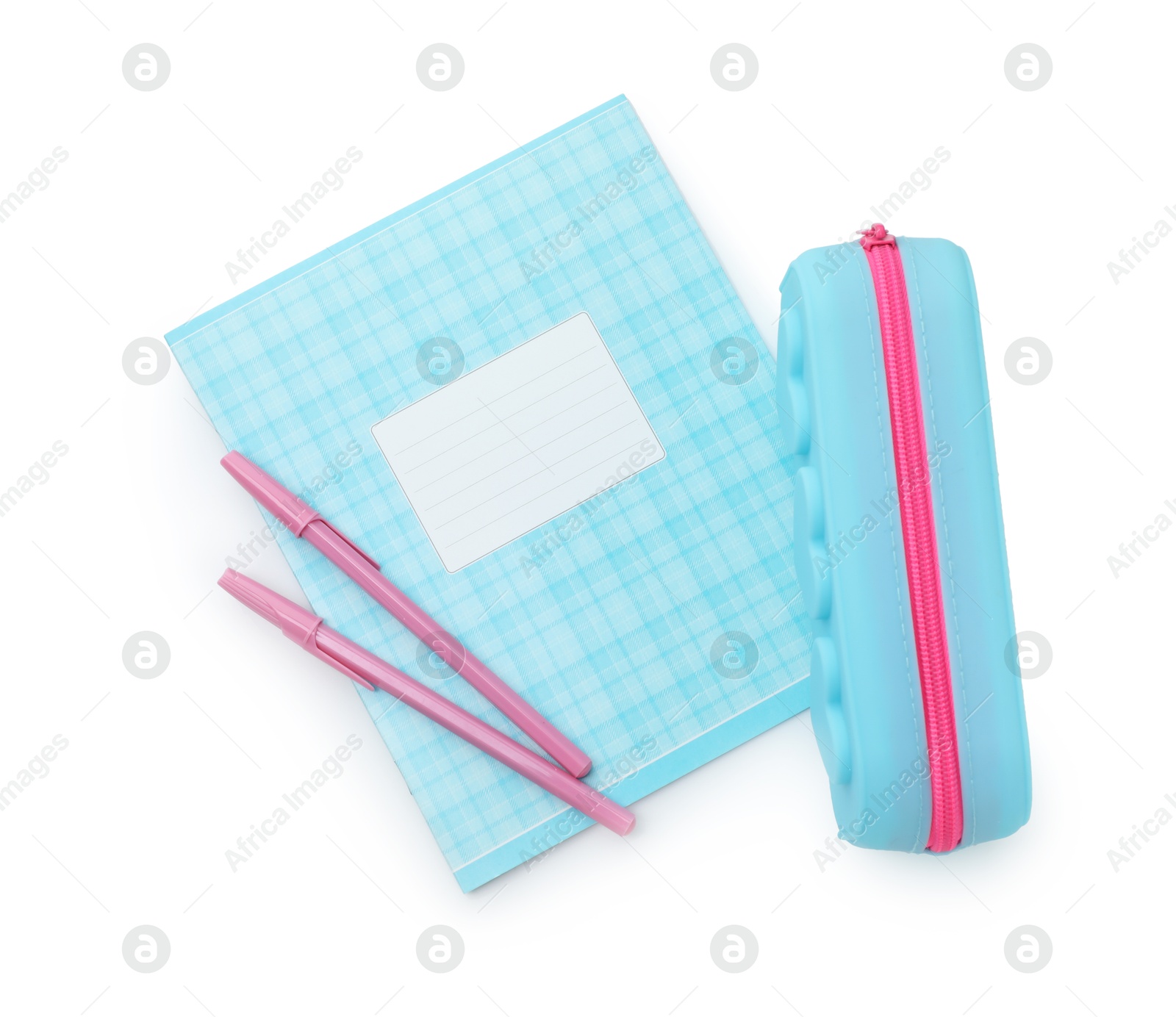 Photo of Copybook, pencil case and pens on white background, top view