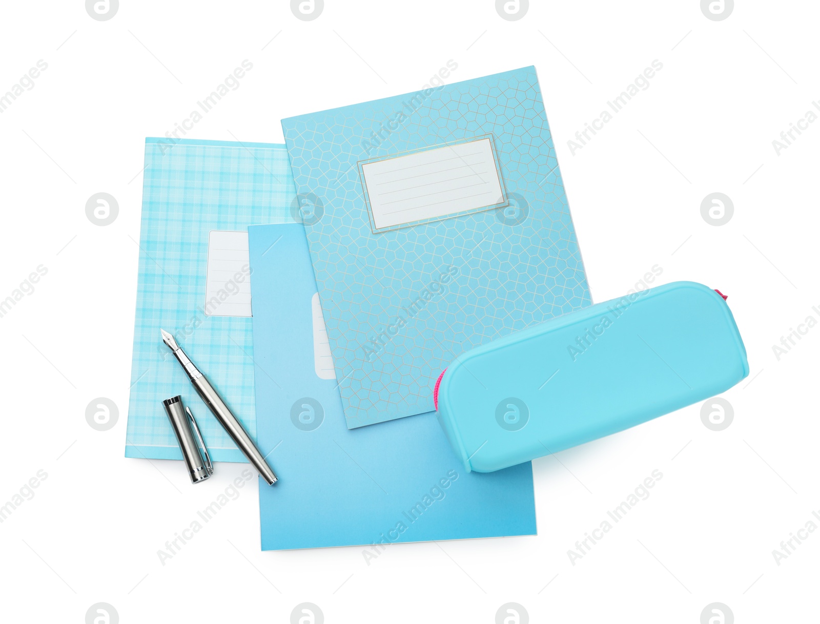 Photo of Copybooks, pencil case and fountain pen on white background, top view