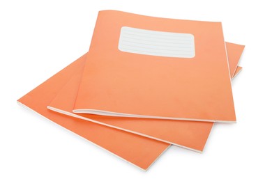 Photo of Orange copybooks isolated on white. School stationery