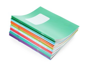 Photo of Stack of colorful copybooks isolated on white