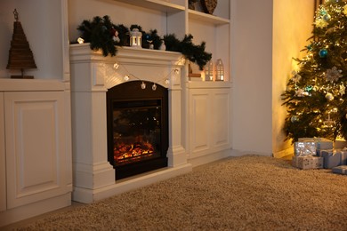 Photo of Decorated fireplace and Christmas tree in room. Festive interior