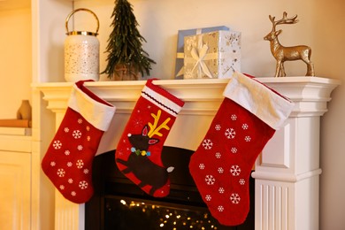 Photo of Fireplace with stockings and Christmas decor indoors