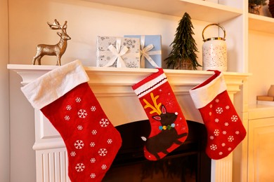 Photo of Fireplace with stockings and Christmas decor indoors