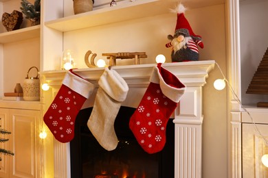 Photo of Fireplace with stockings and Christmas decor indoors