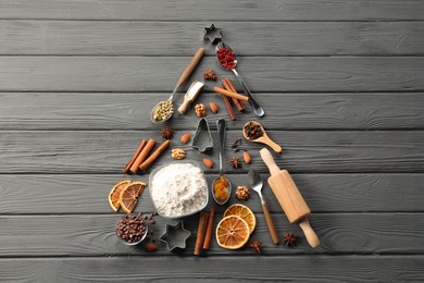 Photo of Christmas tree made with different aromatic spices on grey wooden table, top view