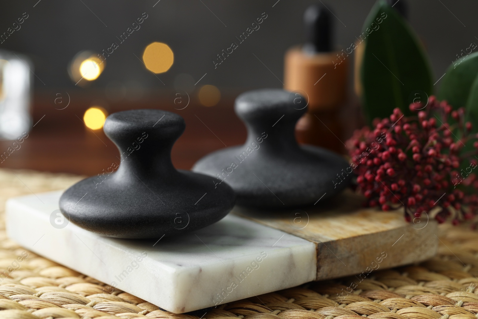 Photo of Spa stones and floral decor on table, closeup