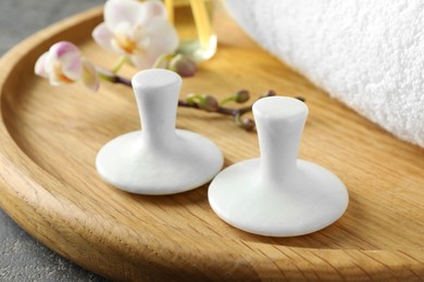 Photo of Spa stones, orchid branch and towel on table, closeup