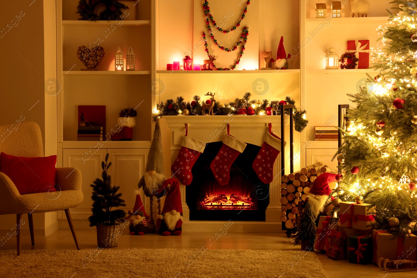 Photo of Stylish fireplace, Christmas tree with festive decor and presents indoors