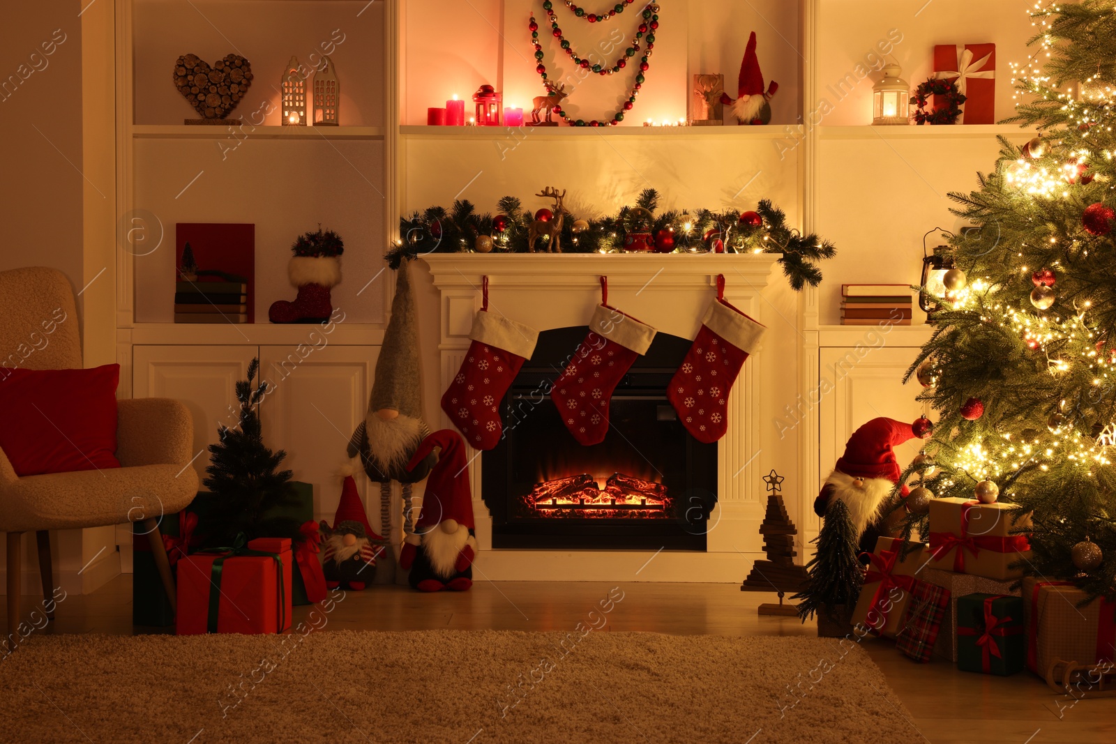 Photo of Stylish fireplace, Christmas tree with festive decor and presents indoors