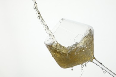 Photo of Pouring wine into glass on white background