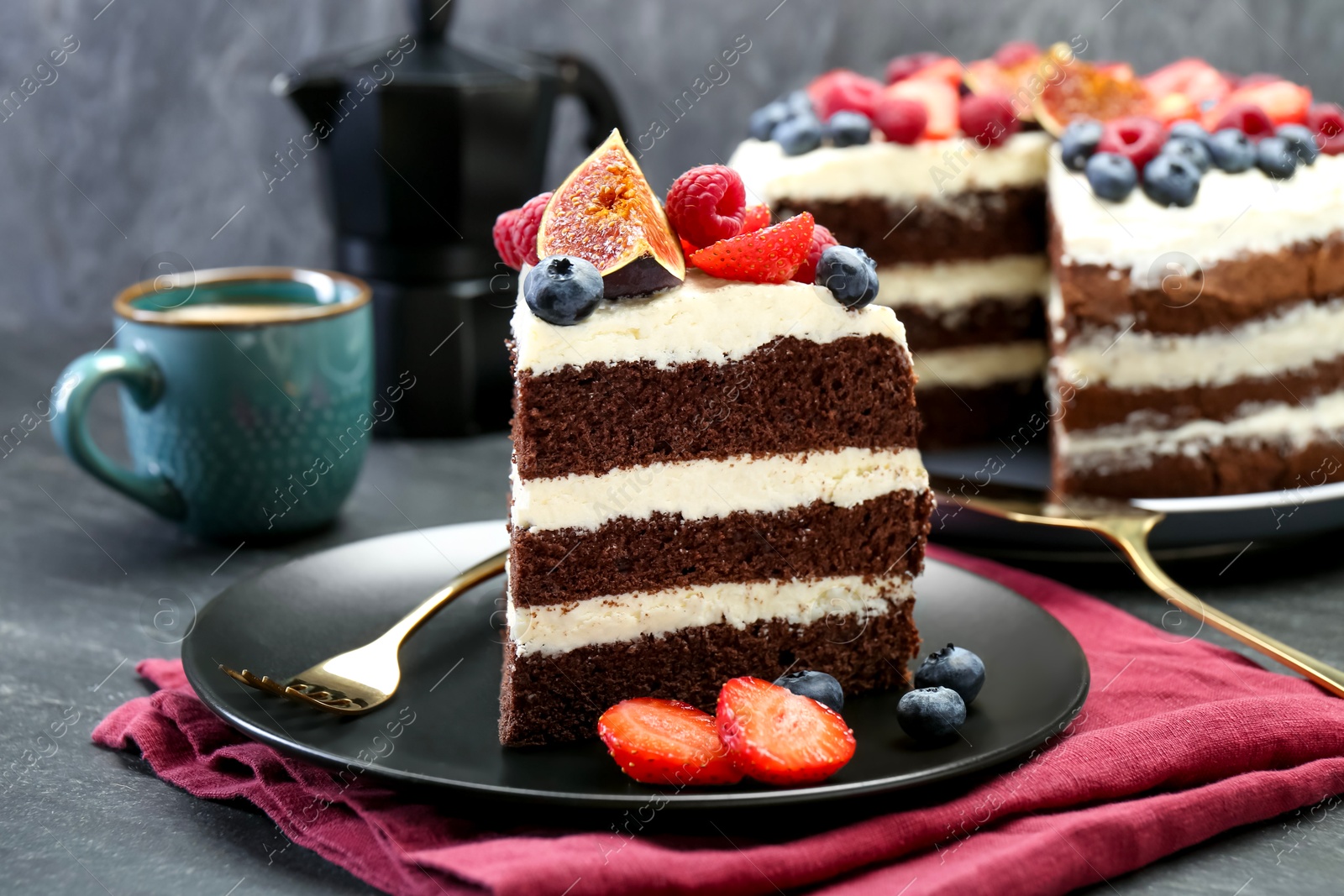 Photo of Piece of delicious chocolate sponge cake with berries served on black table, closeup