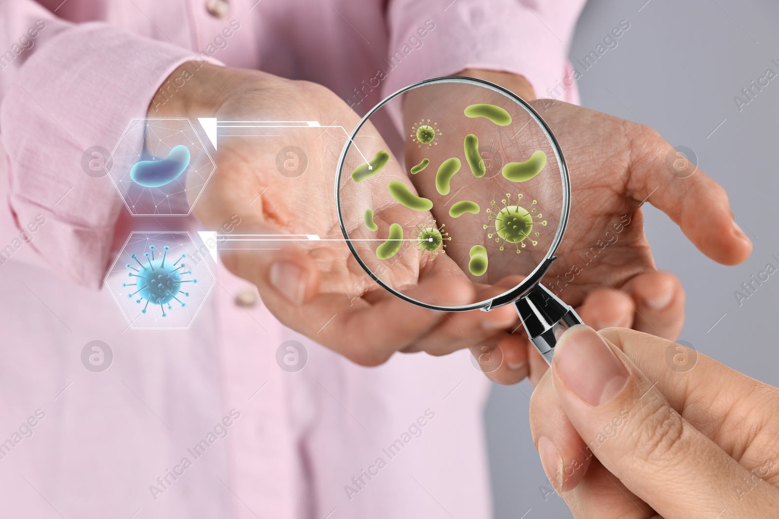 Image of Woman looking at man's hand with magnifying glass, closeup. Illustration of microbes