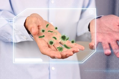 Image of Man showing hand with microbes, closeup. Illustration of microorganisms