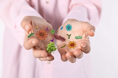 Image of Man showing hands with microbes on white background, closeup. Illustration of microorganisms