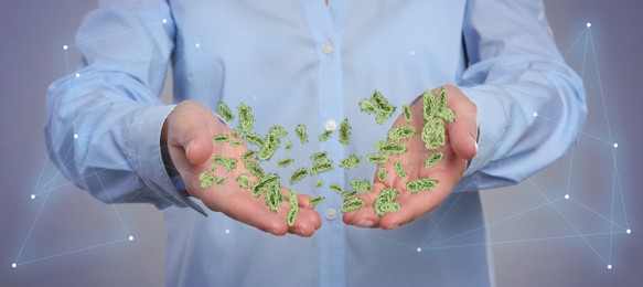 Image of Man showing hands with microbes on grey background, closeup. Illustration of microorganisms