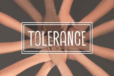 Image of Group of multiracial people joining hands together on grey background, closeup. Tolerance concept