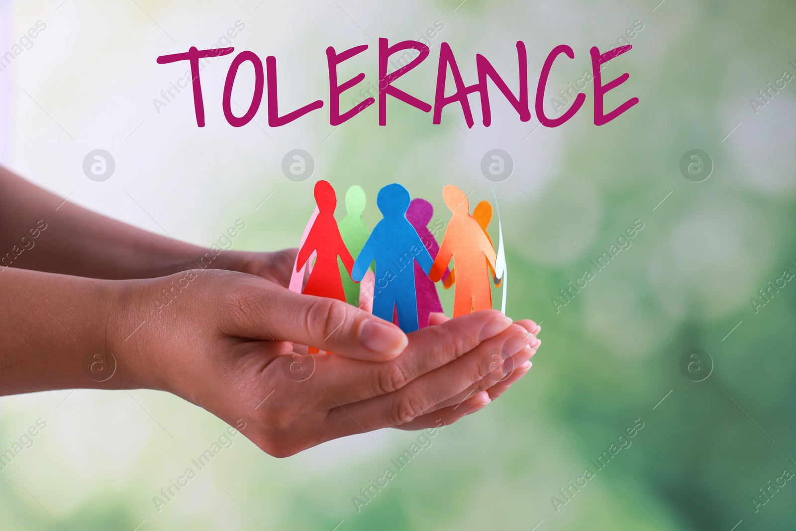 Image of Tolerance concept. Woman holding paper human figures on blurred background, closeup