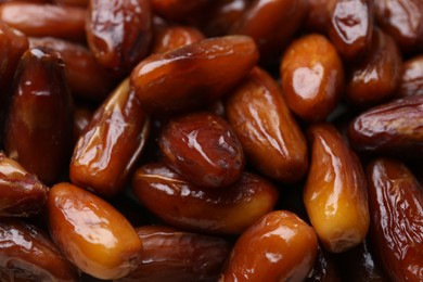 Photo of Tasty sweet dried dates as background, closeup