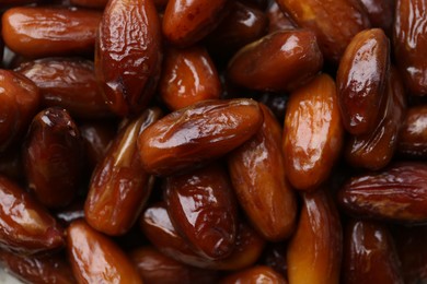 Photo of Tasty sweet dried dates as background, closeup