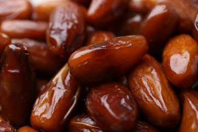 Photo of Tasty sweet dried dates as background, closeup