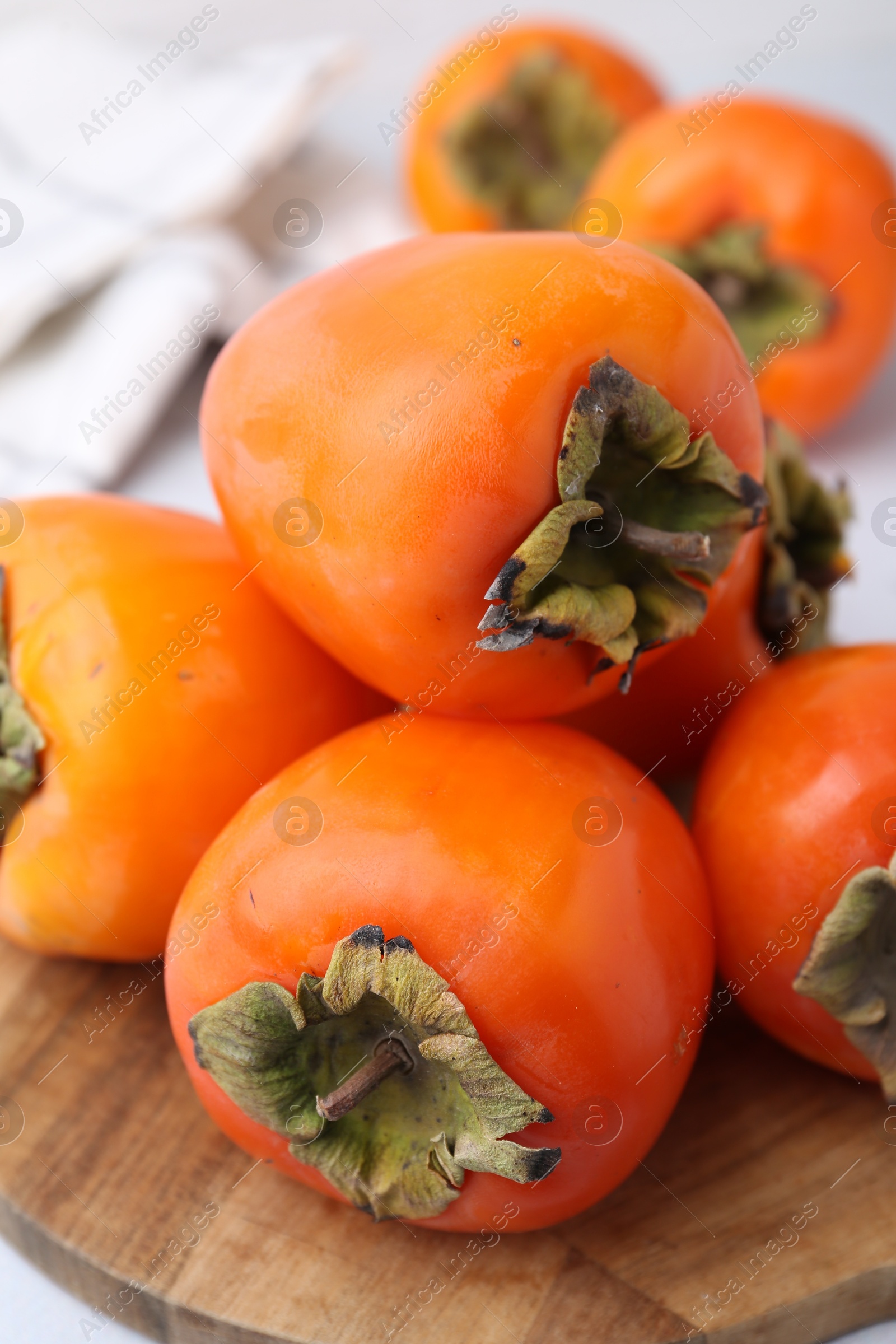 Photo of Delicious fresh juicy persimmons on table, closeup