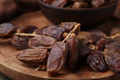 Photo of Tasty dried dates on wooden table, closeup