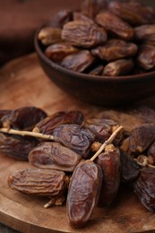 Photo of Tasty dried dates on wooden table, closeup