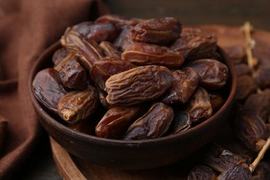 Photo of Tasty dried dates on wooden table, closeup