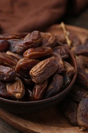 Photo of Tasty dried dates on wooden table, closeup