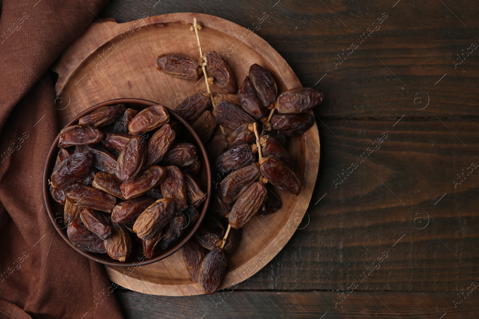 Photo of Tasty dried dates on wooden table, top view