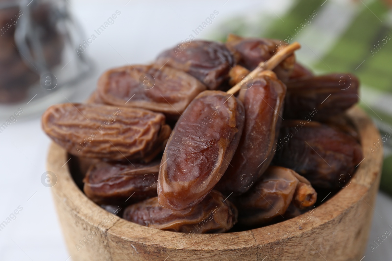 Photo of Tasty dried dates on white table, closeup