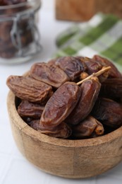 Photo of Tasty dried dates on white table, closeup