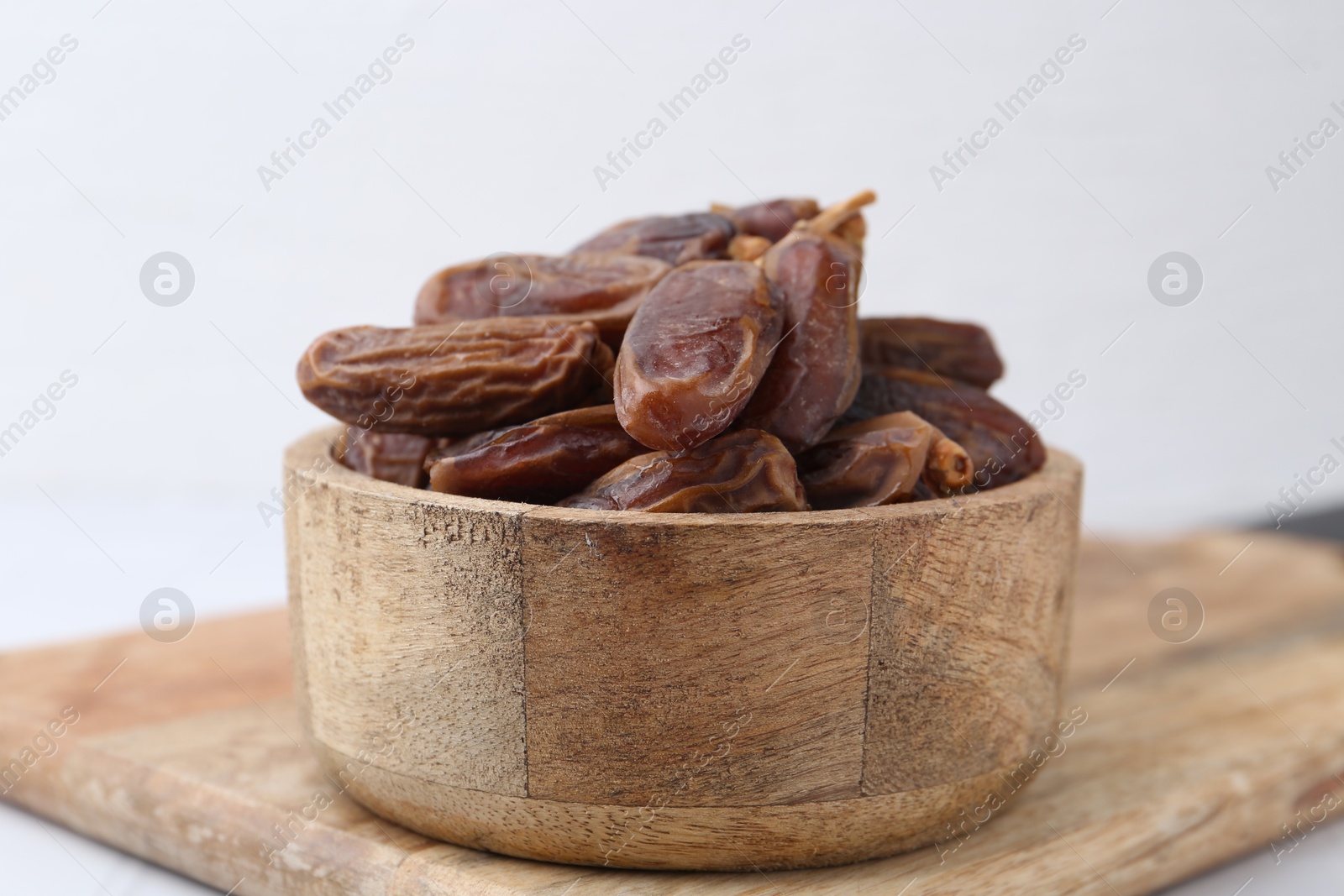 Photo of Tasty dried dates on light table, closeup