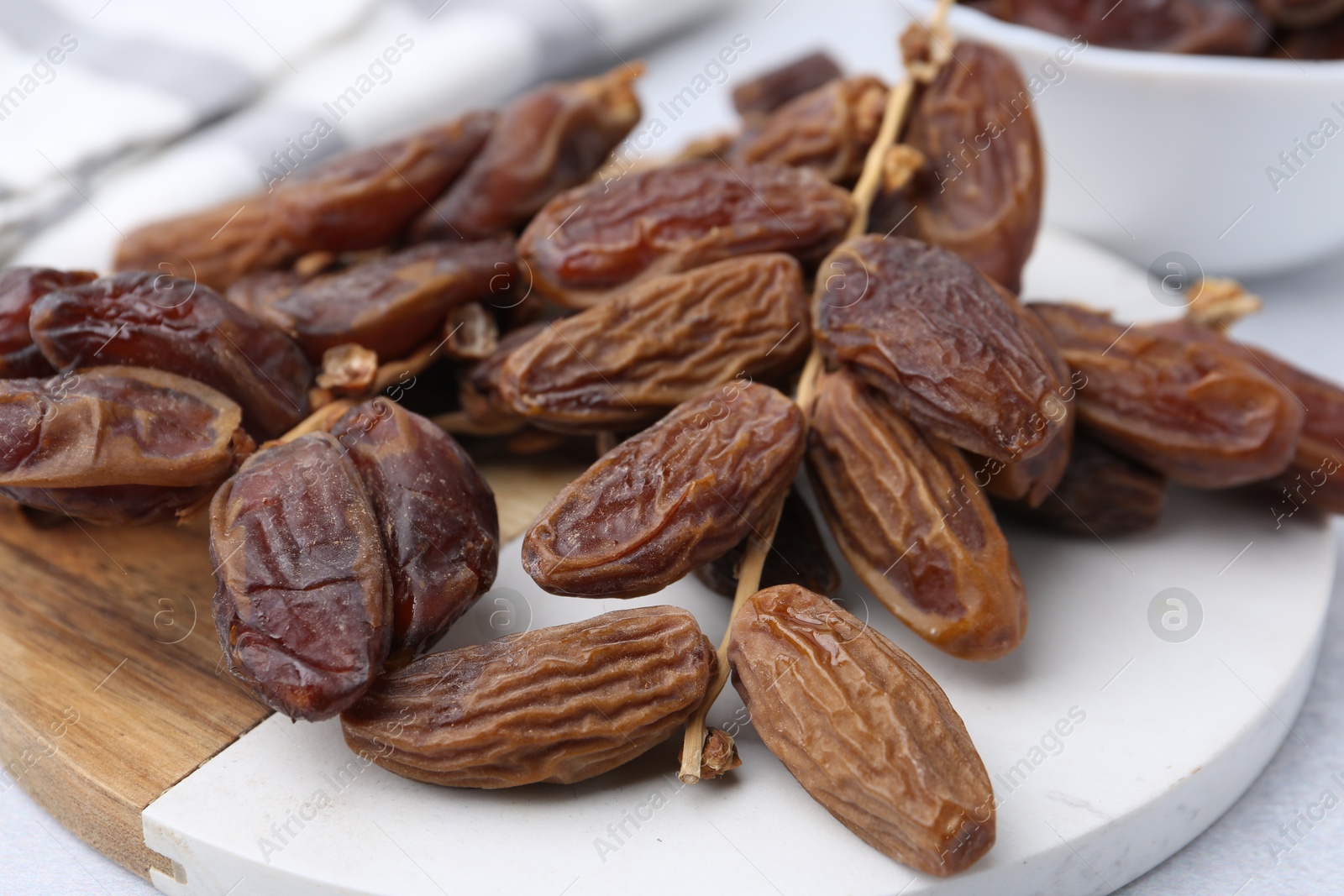 Photo of Tasty dried dates on light table, closeup