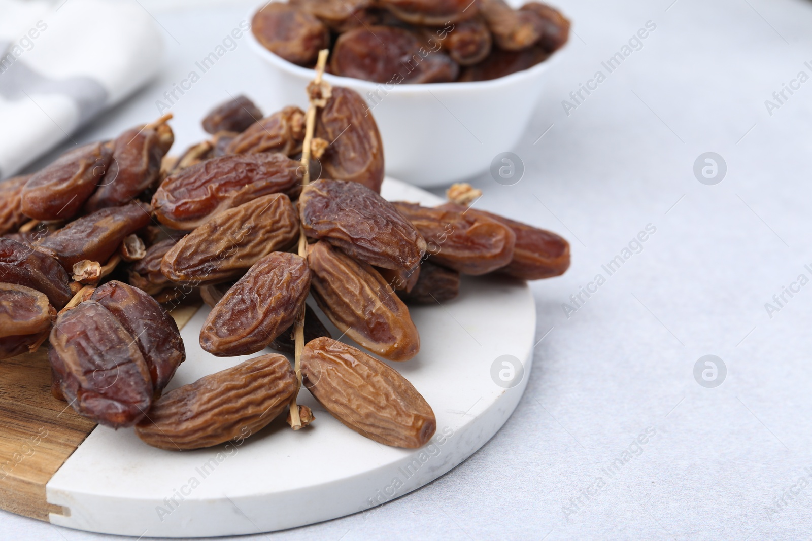 Photo of Tasty dried dates on light table, closeup