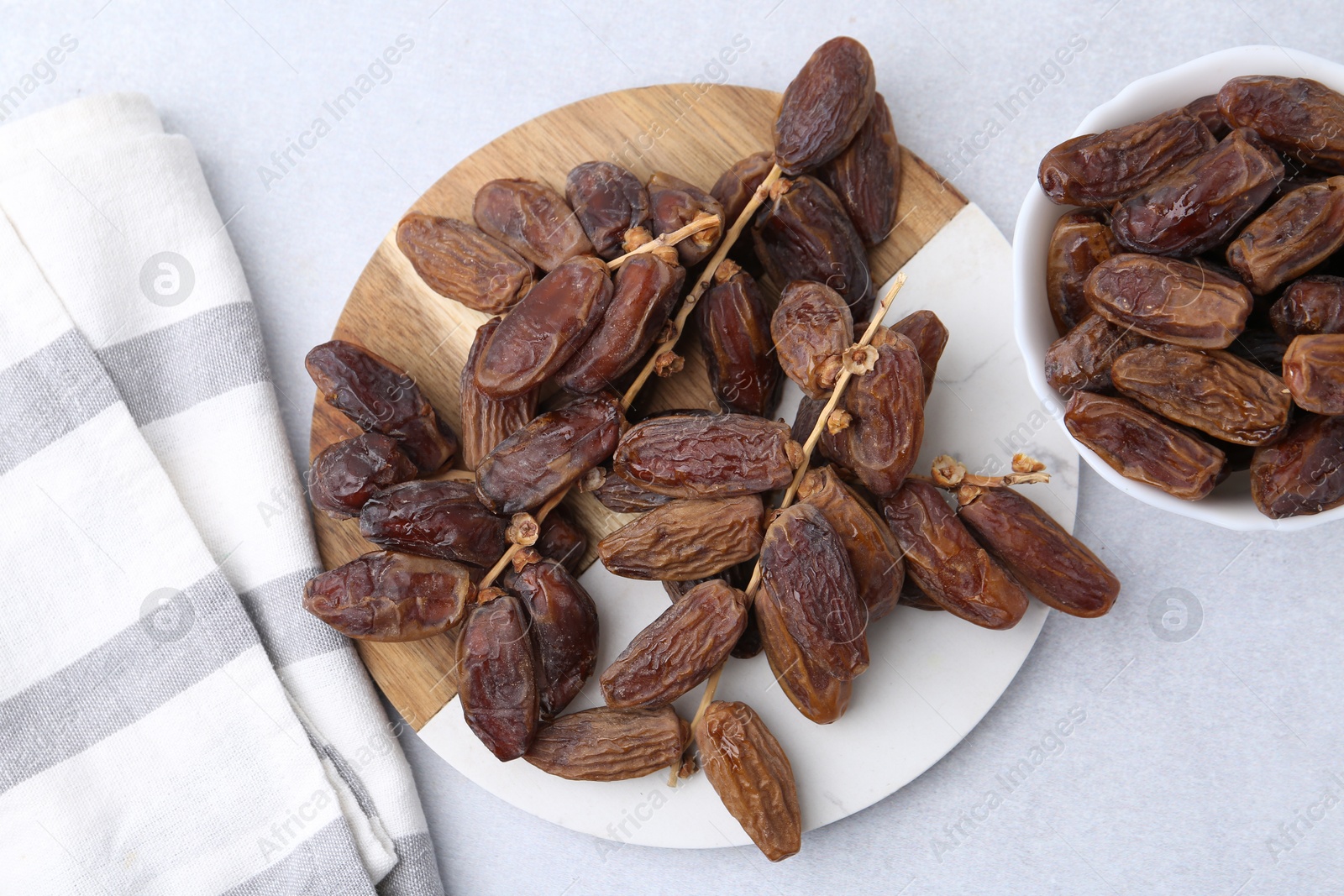 Photo of Tasty dried dates on light table, top view