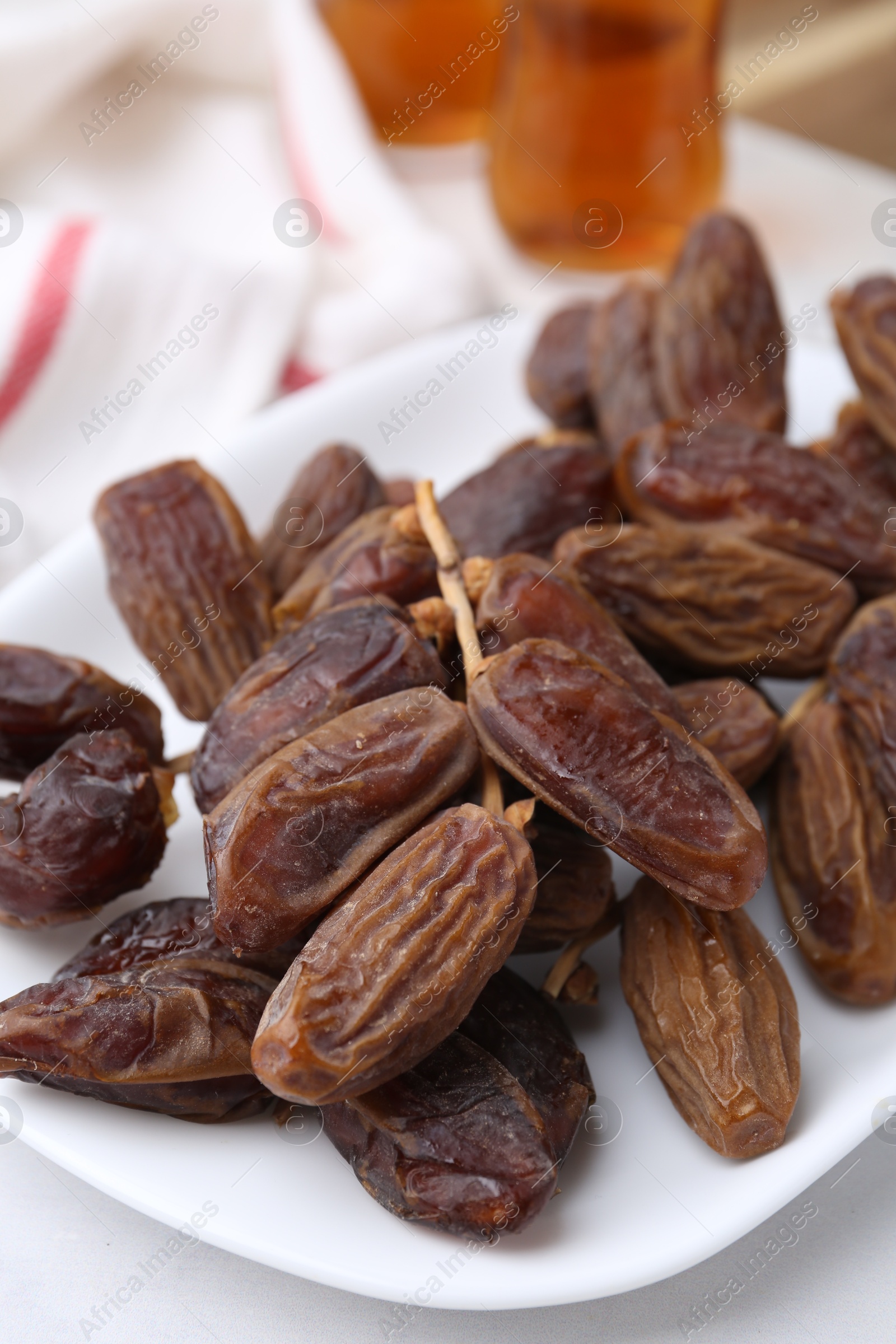 Photo of Tasty dried dates on white table, closeup