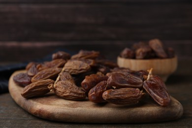 Photo of Tasty dried dates on wooden table, closeup