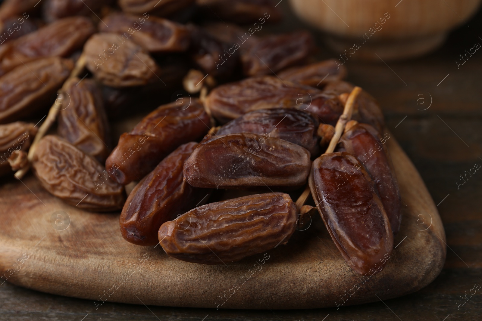 Photo of Tasty dried dates on wooden table, closeup