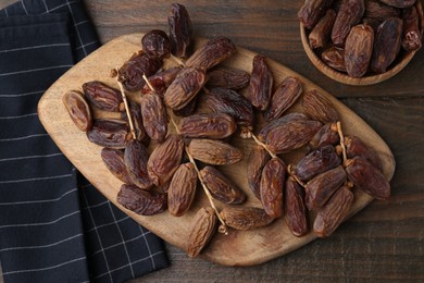 Photo of Tasty dried dates on wooden table, top view