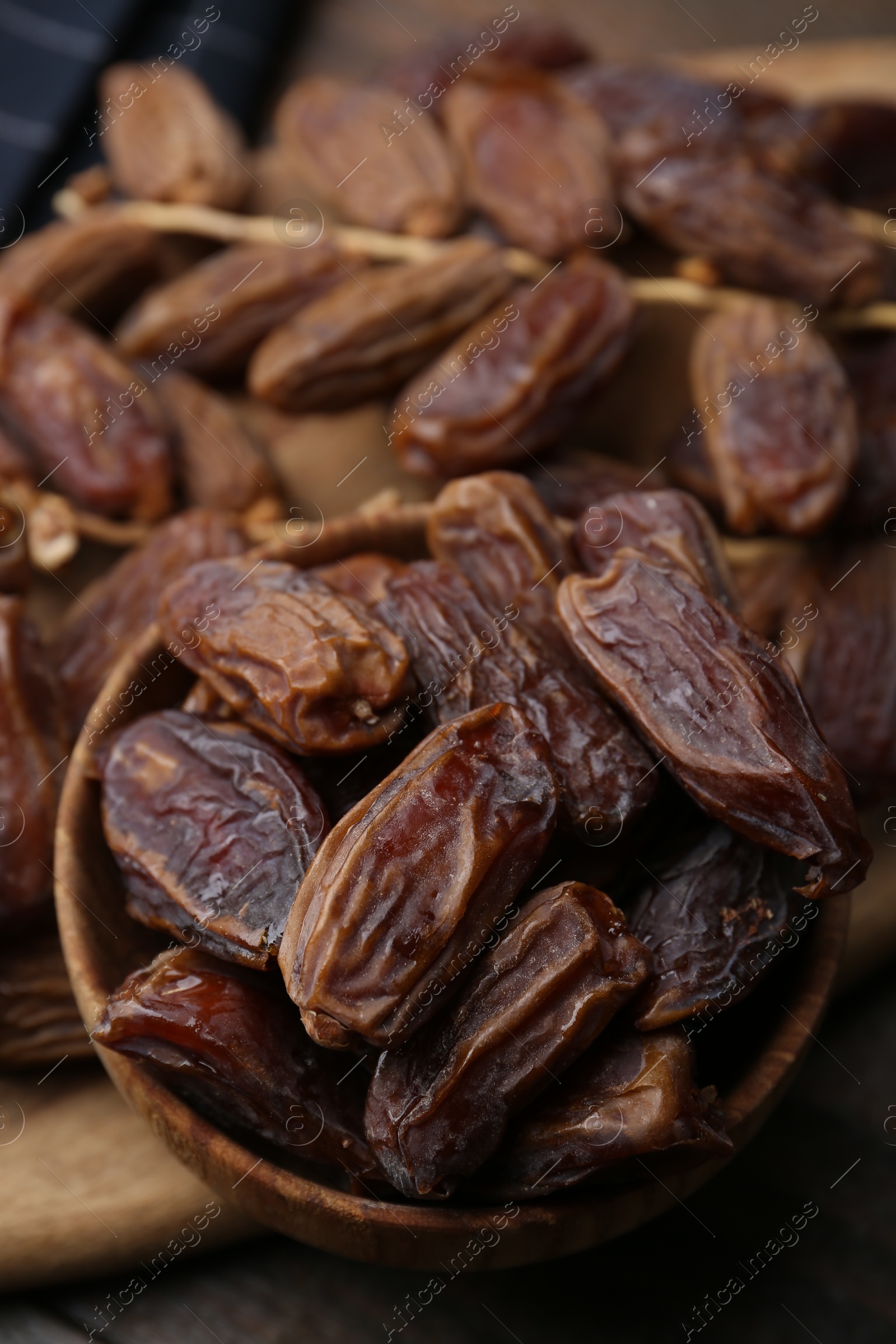 Photo of Tasty dried dates on wooden table, closeup