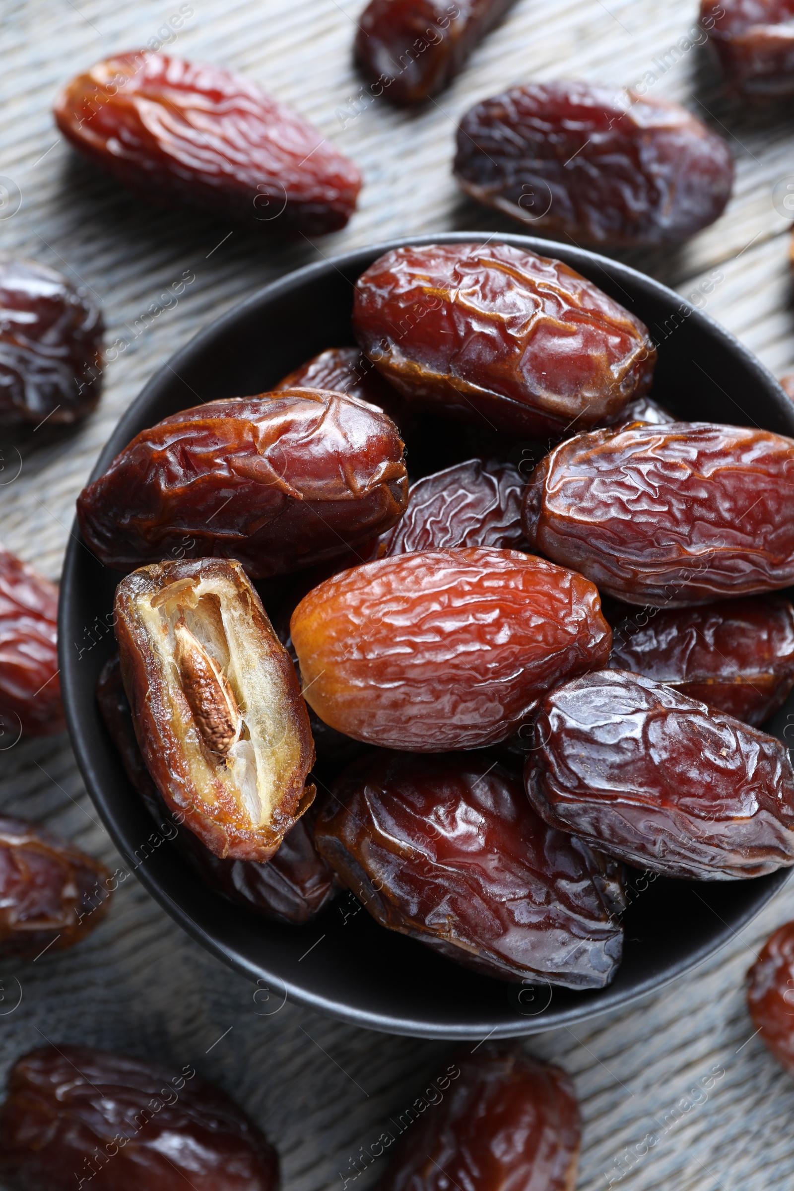 Photo of Tasty dried dates on light wooden table, flat lay