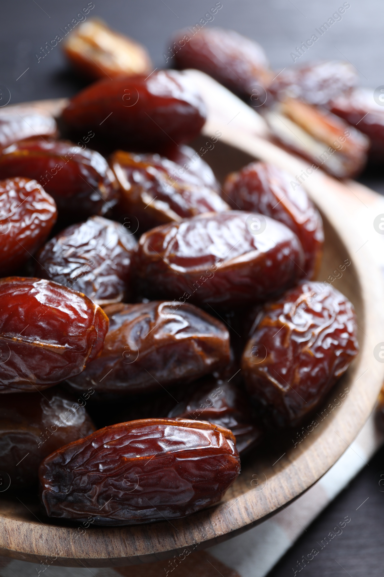 Photo of Tasty dried dates on black table, closeup