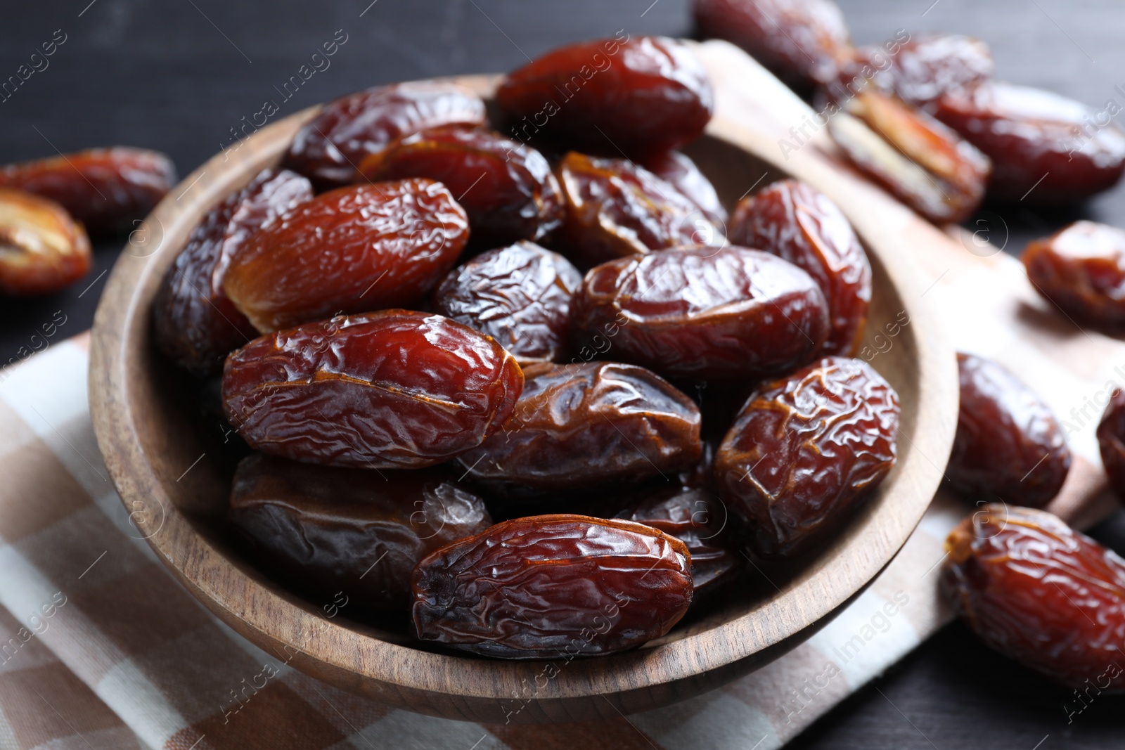 Photo of Tasty dried dates on black table, closeup