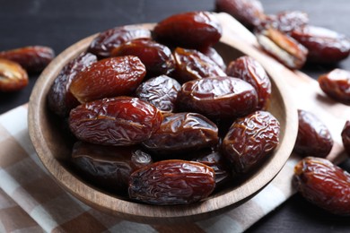 Photo of Tasty dried dates on black table, closeup