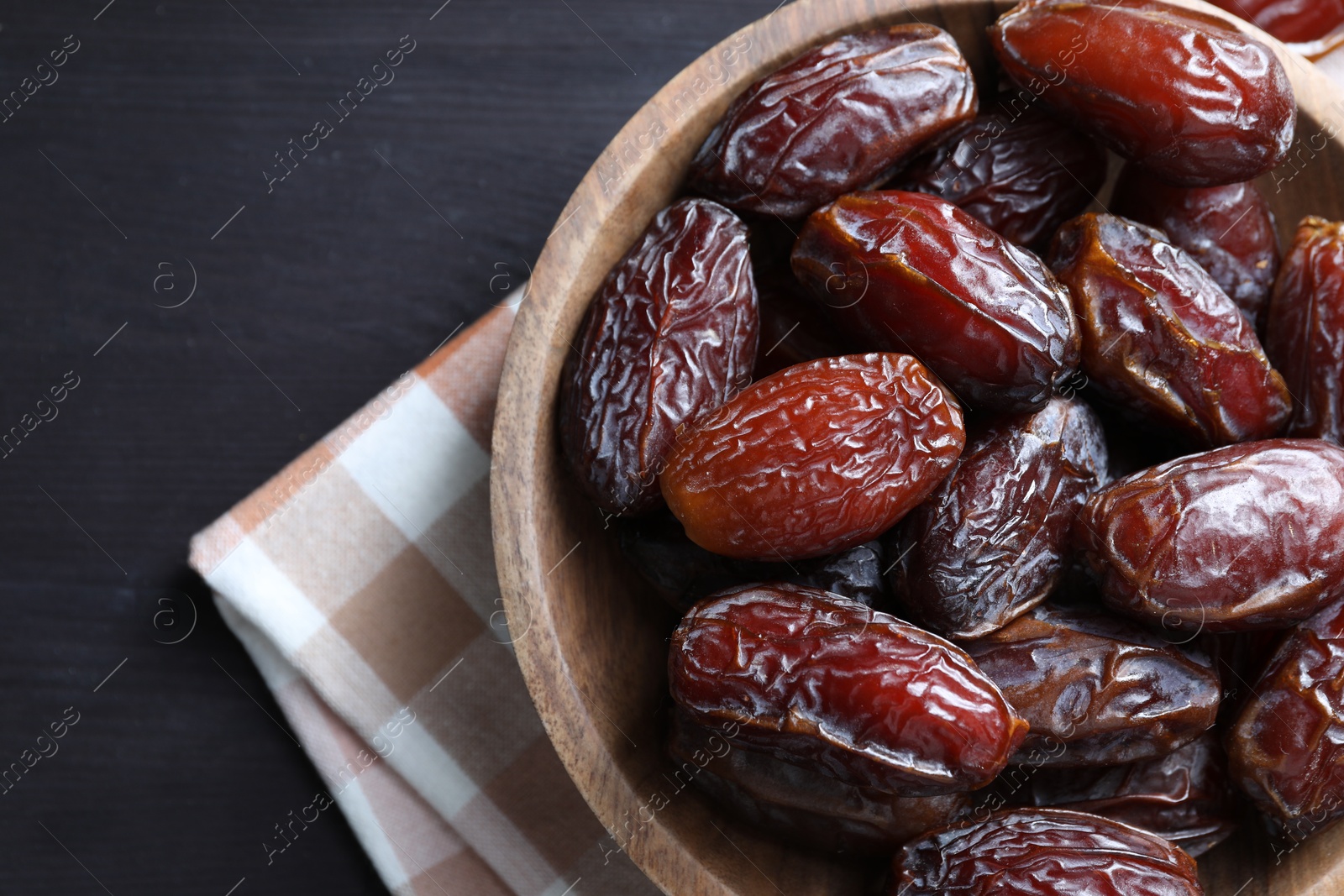 Photo of Tasty dried dates on black table, top view