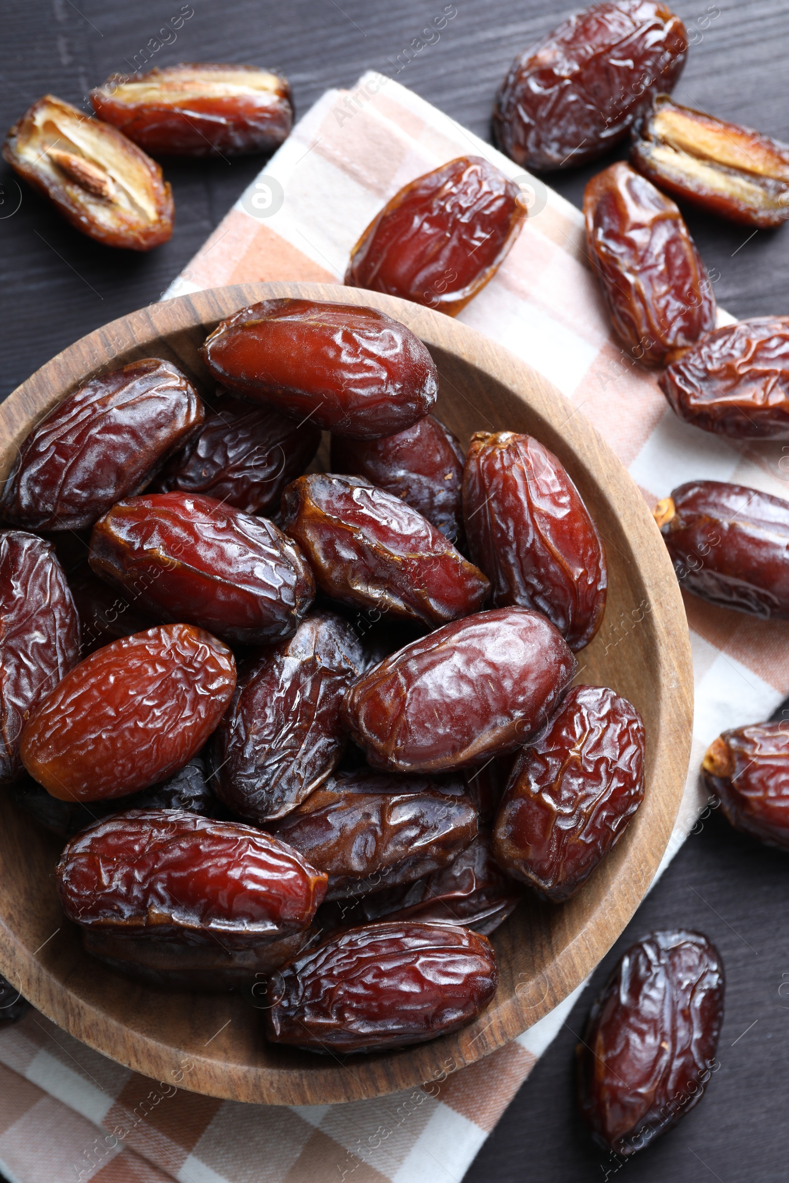 Photo of Tasty dried dates on black table, top view