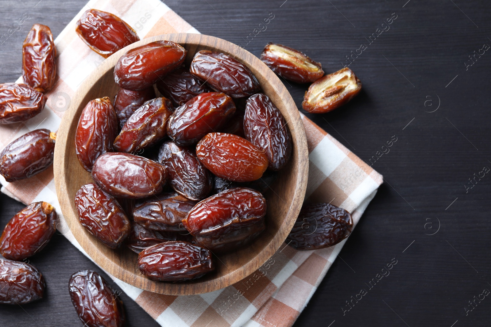 Photo of Tasty dried dates on black table, top view