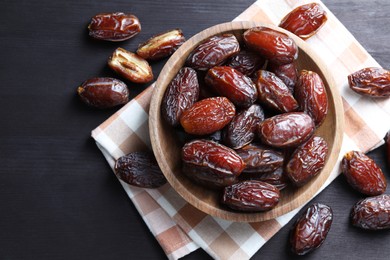 Photo of Tasty dried dates on black table, top view