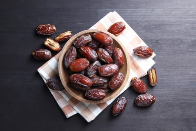 Photo of Tasty dried dates on black table, top view